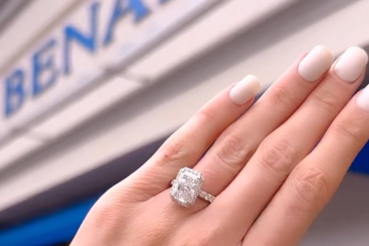 A halo ring with emerald cut center stone outside BENARI JEWELERS A halo ring with emerald cut center stone outside BENARI JEWELERS